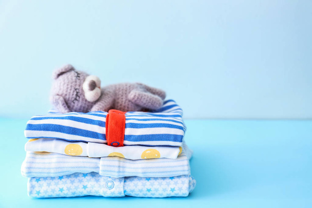 Stack of baby clothes on color background - Photo, Image