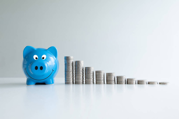 blue piggy money bank with coins bar graph, step up growing business to success and saving for retirement concept - Photo, Image