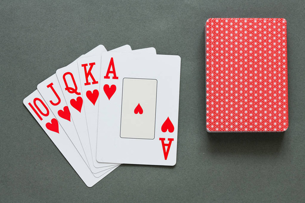 Royal Straight Flush játékkártya, szürke háttér, póker koncepció  - Fotó, kép