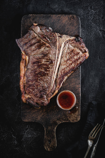 Grilled Dry Aged T-bone Steak on Rustic Chopping Board. USDA Prime Beef. - Fotó, kép