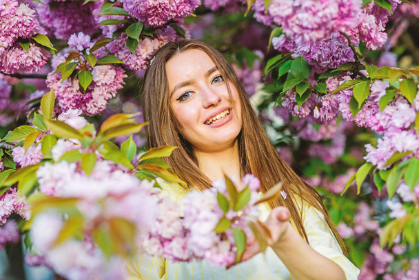 i am a spring. girl in cherry flower. Sakura tree blooming. woman in spring flower bloom. skincare and spa. Natural cosmetics for skin. blossom smell, allergy. natural summer beauty - 写真・画像