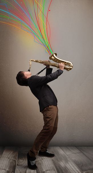 Attractive musician playing on saxophone while colorful abstract - Φωτογραφία, εικόνα