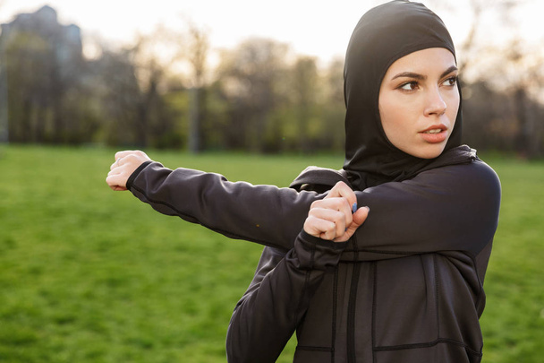 Portrait of fitness muslim woman dressed in religious black hija - Zdjęcie, obraz