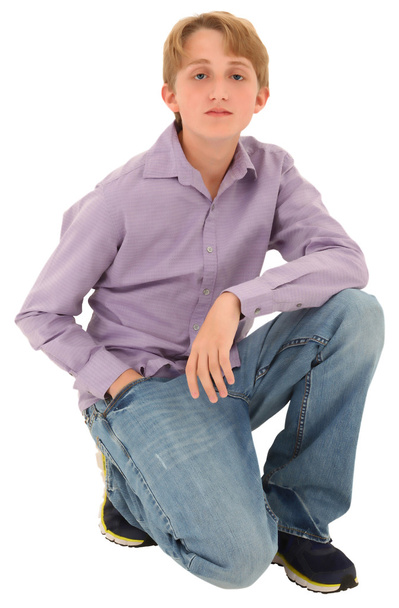 Handsome casual Caucasian teen boy over white background. - 写真・画像