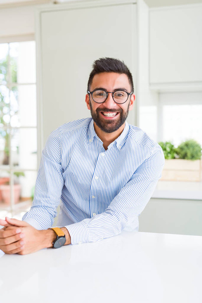 Handsome business man wearing glasses and smiling cheerful with confident smile on face - Photo, image