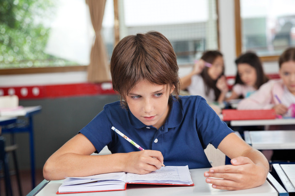 Schoolboy Cheating At Desk During Examination - Fotó, kép