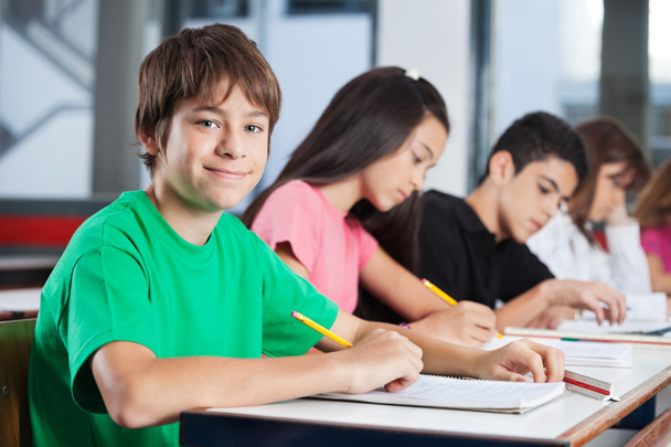Teenage Boy With Friends Studying At Desk - Фото, зображення