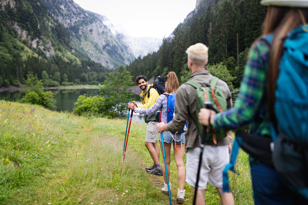 Group of happy people friends hiking together outdoor - Photo, image