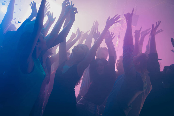 Close up photo of many birthday party people dancing clubbing purple lights confetti fog nightclub hands raised shiny formal-wear - Foto, Bild