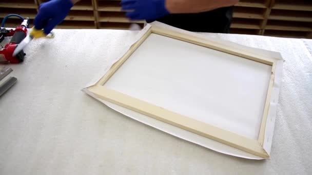 Stretching the canvas on the wooden frame of the picture - Footage, Video