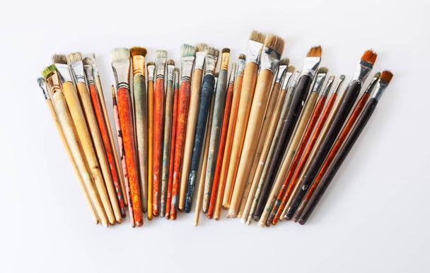 Many used paint brushes isolated on white background - 写真・画像