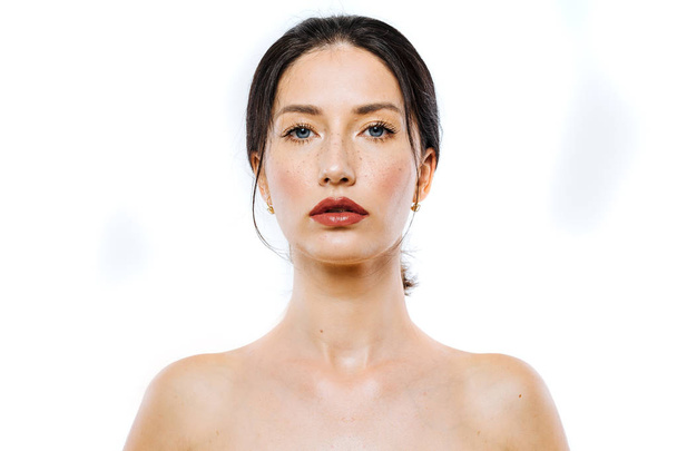 Portrait of beautiful brunette woman model with freckles and blue eyes - Fotó, kép