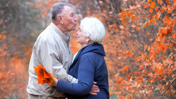 Elderly man kisses the woman's forehead - Фото, зображення