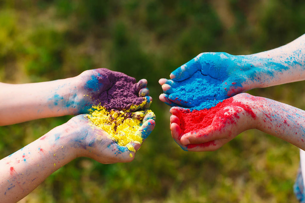 Hands Palms of young people covered in purple, yellow, red, blue Holi festival colors isolated. - Photo, Image