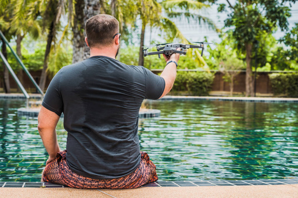 a man launches a drone for flight, with which you can take photos and video filming - Fotoğraf, Görsel