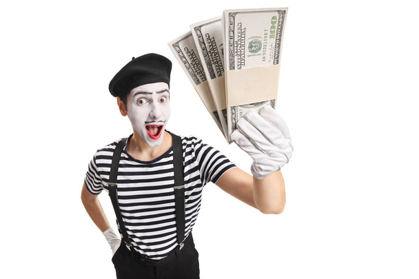 Surprised mime holding money - Valokuva, kuva