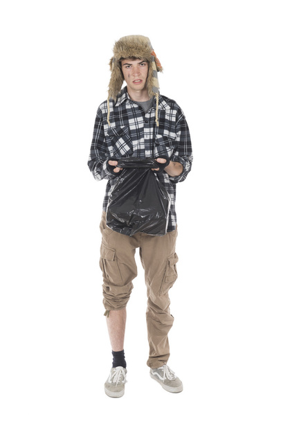 Homeless wanderer with a garbage bag in hand - Foto, imagen