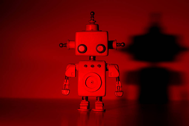 Robot on a red background. - Foto, afbeelding