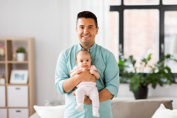 middle aged father with baby daughter at home - Photo, Image