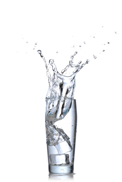 Glass of water with ice cubes on white background. Water splash - Zdjęcie, obraz