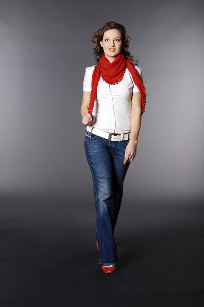 Brunette girl in a red scarf - Фото, зображення