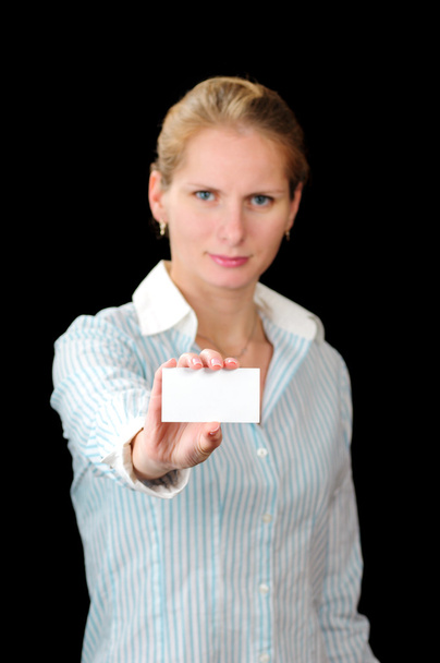 Young blond girl with white card isolated on black background - 写真・画像