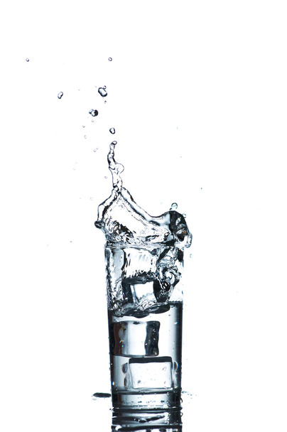 Glass of water with ice cubes on white background. - Photo, Image