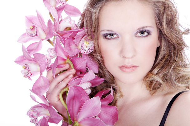 ピンクの花を持つブロンドの女の子 - 写真・画像