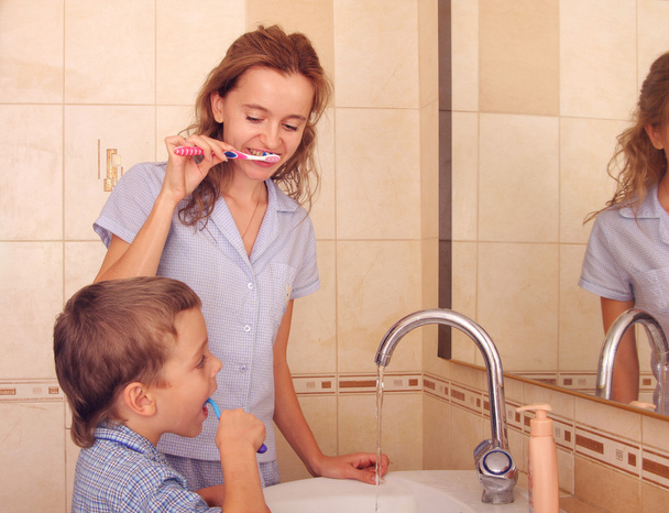 Child with mum clean a teeth - Foto, Imagen