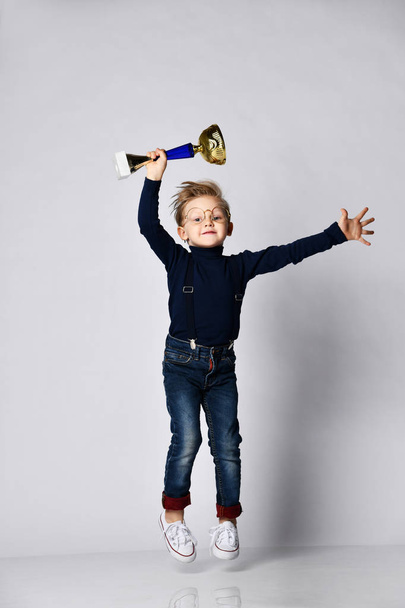 Little boy celebrates his golden trophy - Zdjęcie, obraz