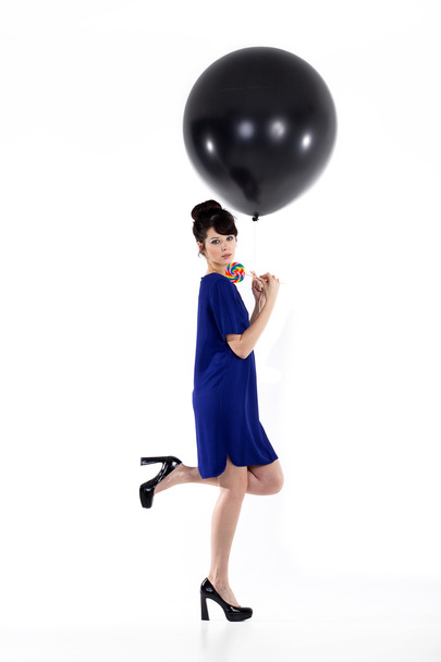 Brunette girl with balloon and sweet candy - Valokuva, kuva
