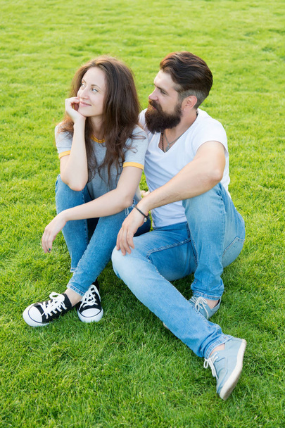 Cute couple. fashion couple having fun together. cute girl and bearded man hipster on green grass. couple in love. Students life. family weekend. summer relax in park - Photo, Image