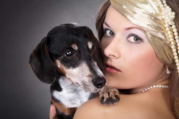 Girl holding a dog - Photo, image