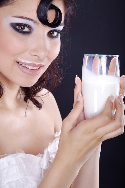 Brunette girl drinking milk - 写真・画像