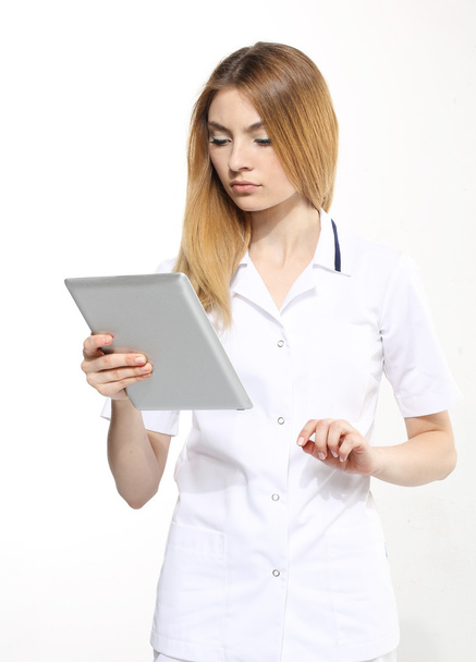 Female doctor working on digital tablet - Photo, image