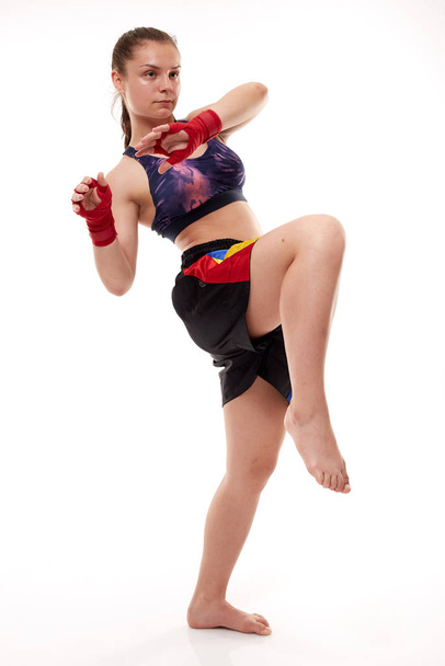 Young girl kickboxing fighter training, isolated on white background - Photo, image