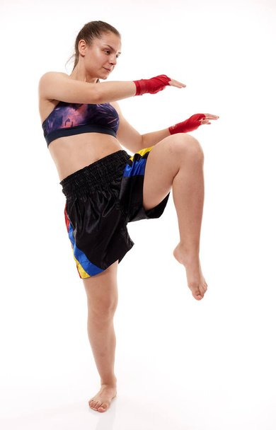 Young girl kickboxing fighter training, isolated on white background - Фото, зображення
