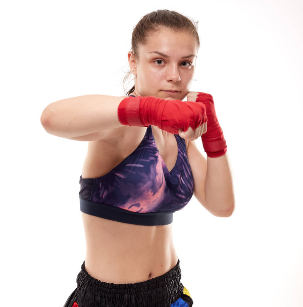 Young girl kickboxing fighter training, isolated on white background - Valokuva, kuva