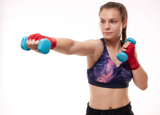 Young girl kickboxing fighter training, isolated on white background - Foto, Imagen