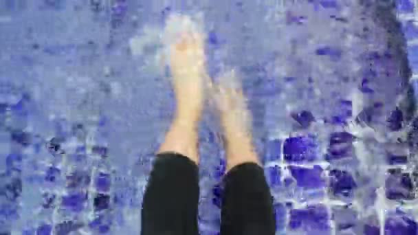 Weibliche Beine auf der Wasseroberfläche des Freibades, Archivmaterial - Filmmaterial, Video