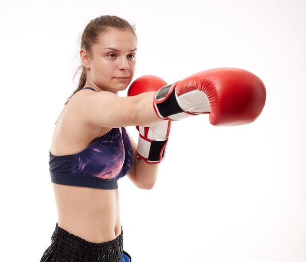 Young girl kickboxing fighter training, isolated on white background - Zdjęcie, obraz