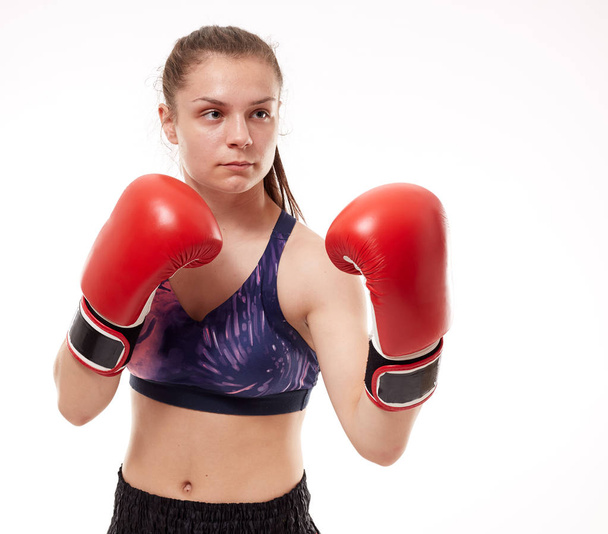 Young girl kickboxing fighter training, isolated on white background - Fotoğraf, Görsel