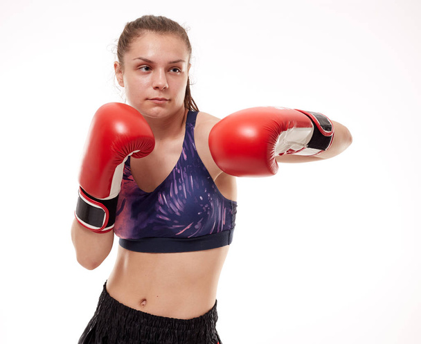 Young girl kickboxing fighter training, isolated on white background - Foto, imagen