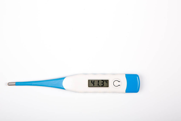 Digital thermometer measuring slight fever isolated on white - Photo, Image