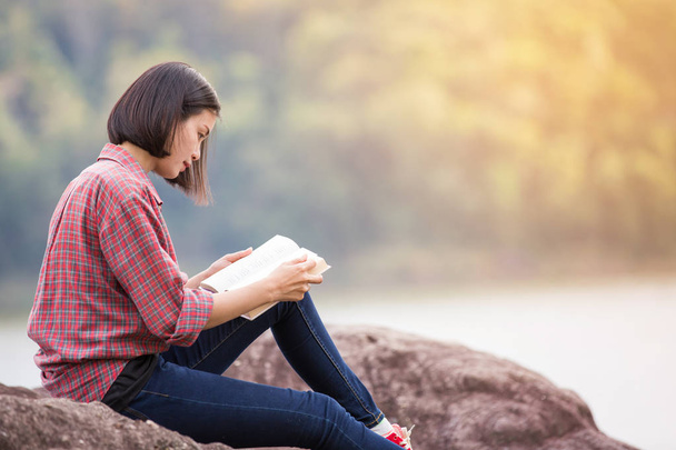 beautiful woman reading a book in the nature - Фото, зображення