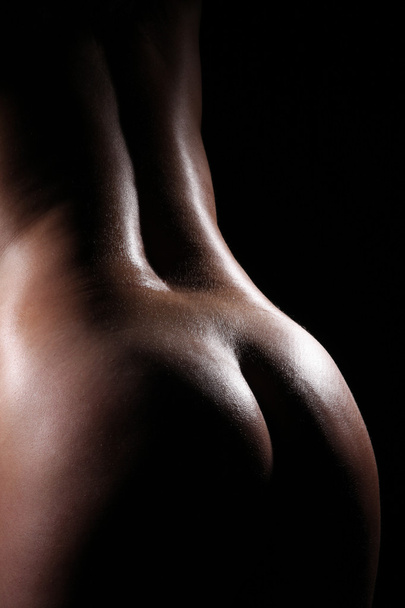 Naked female body on a black background - 写真・画像