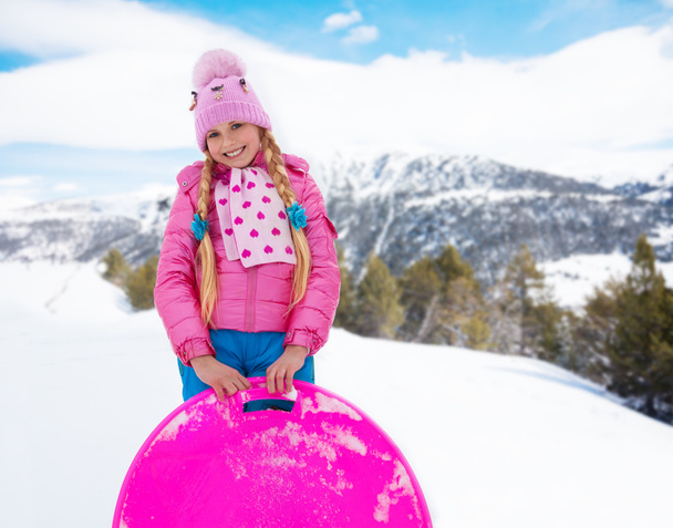 Happy girl in pink with sled - Φωτογραφία, εικόνα