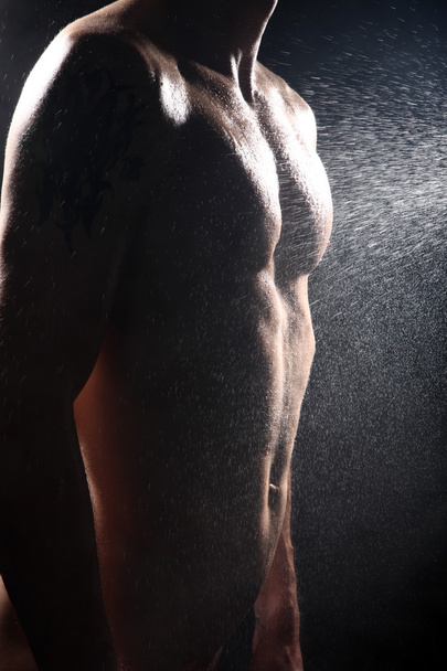 Naked man on a black background - Photo, image