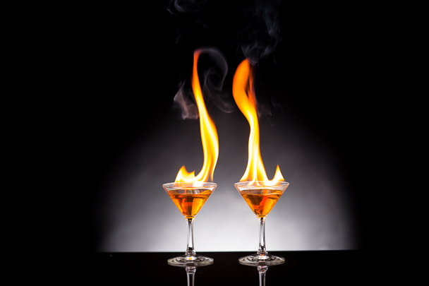 wine glass with burning alcohol on black background - Foto, imagen