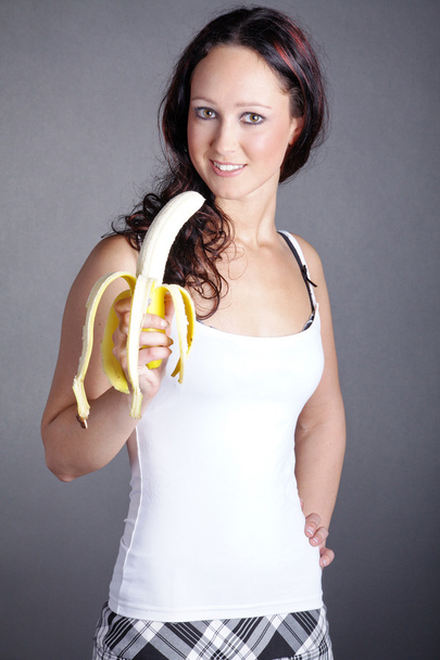 Brunette girl with a banana - Valokuva, kuva